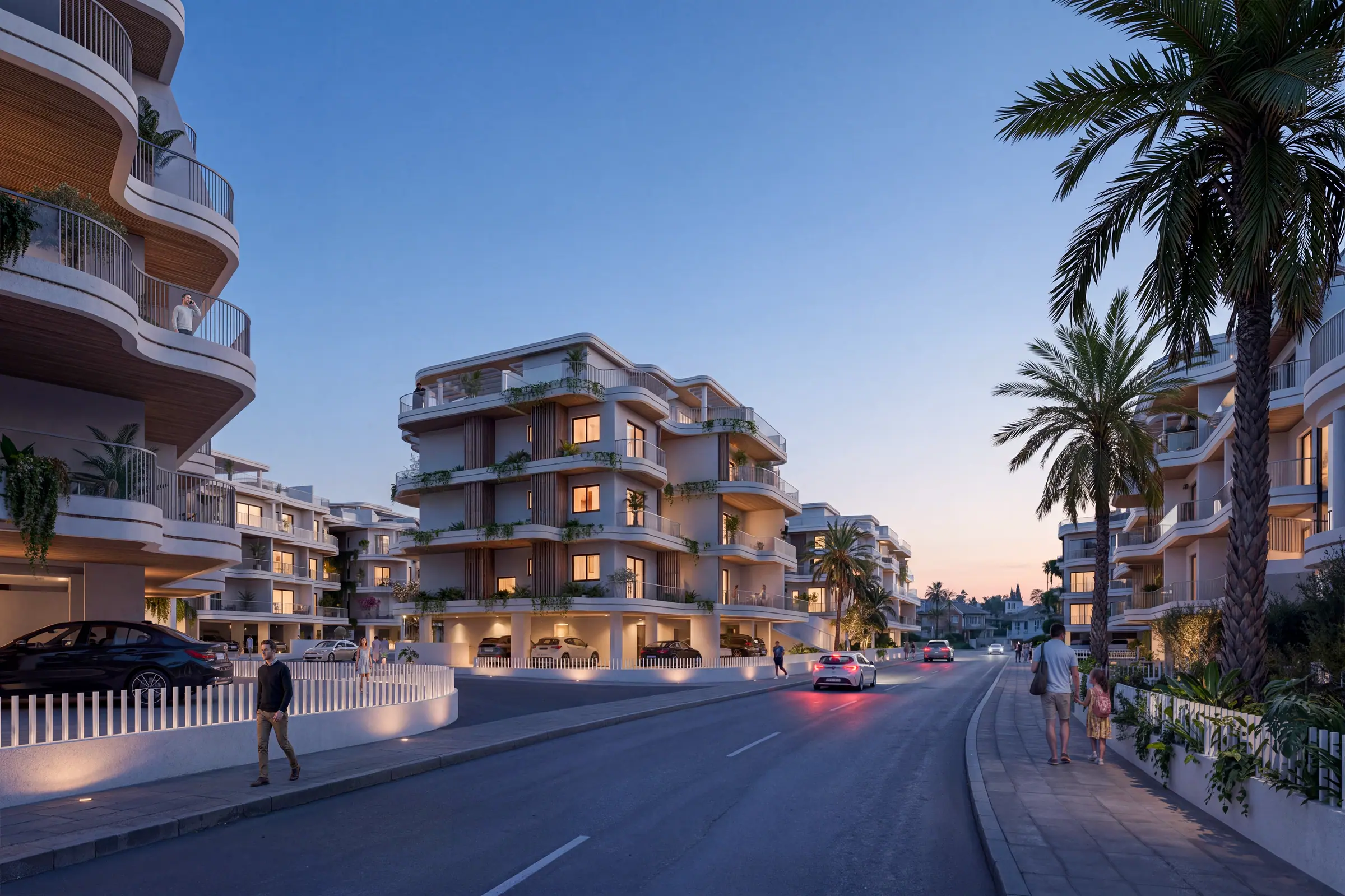 The development at dusk with warm light spilling from the terraces