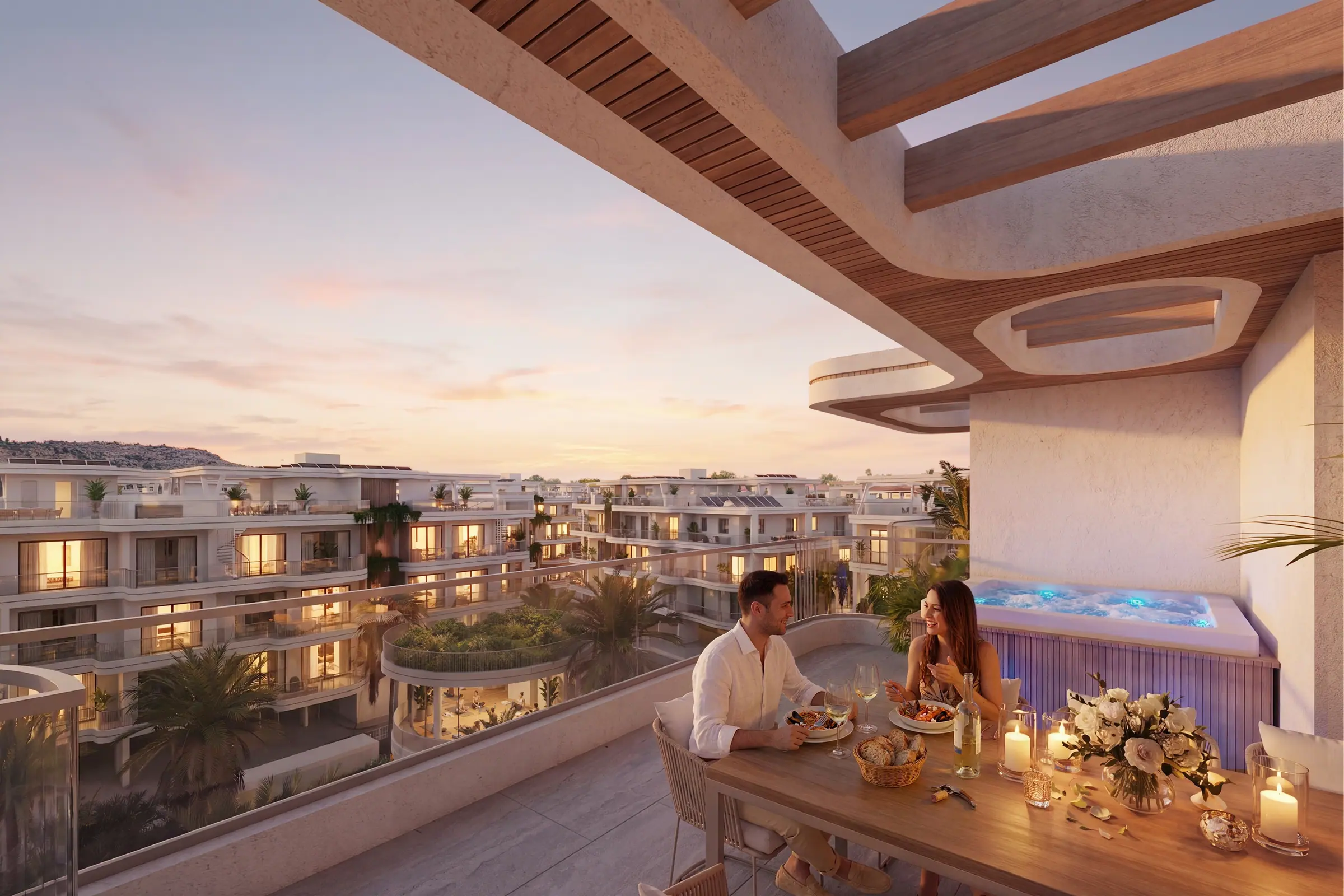 Rooftop terrace dining as the sun sets over the development